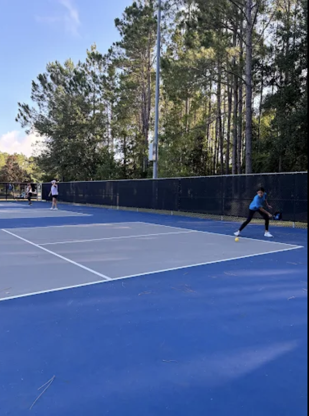Blue acrylic pickleball courts with players at Veterans Park in St. Johns, Florida